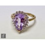 A 9ct hallmarked amethyst and diamond cluster ring, central pear shaped amethyst, length 16mm,