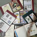 A collection of World Cup football stamps and coin inset covers contained in nine albums and loose