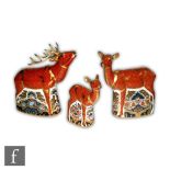 A Royal Crown Derby Sherwood set comprising Stag paperweight, Hind paperweight and Fawn