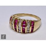 A 9ct hallmarked ruby and diamond ring comprising seven alternative rows of four vertically set