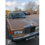 A 1981 Rolls Royce Silver Spirit motor vehicle in gold finish, 6.5 litre, four door with cream