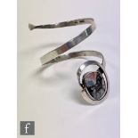 A Sterling silver arm cuff bangle detailed with collar set polished agate, impressed Sterling Bali.