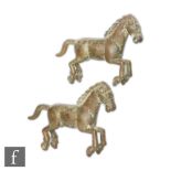 A pair of Chinese Tang style cast metal figures of horse, each modelled in rearing position, with