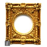 A late 19th century carved and gilded Florentine style picture frame with scallop and scrolling