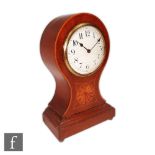 An Edwardian inlaid balloon shaped mantle clock, white circular dial over a stepped base inlaid with