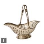 An early 20th Century silver basket by Martin Hall & Co of footed boat shape with pierced body and a