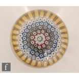 A 20th Century Whitefriars glass paperweight, with concentric rings of millefiori ruffle and cog