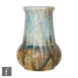 A small Ruskin Pottery vase of globe and shaft form decorated with a blue dribble glaze over a