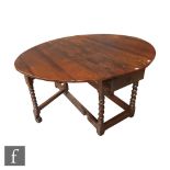 A large 19th Century and later constructed oak oval gateleg dining table with single end drawer on