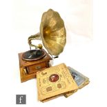 A replica HMV style brass horn wind up gramophone and a small quantity of 78rpm records.