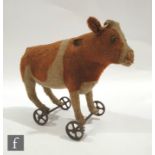 An early 20th Century Steiff cow or ox on wheels, Article No. 1322, circa 1910, brown and white