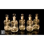 A set of five miniature scrooge decanters, white metal collars engraved with monogram, height