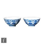 A pair of Chinese 'Buddhist emblem' blue and white bowls, Qianlong six-character (1736-95), the