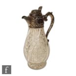 A hallmarked silver and clear glass claret jug, the baluster cut glass body below silver part