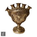 A continental silver five flute pedestal tulip vase with embossed and engraved foliate decoration,