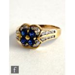 An 18ct sapphire and diamond cluster ring, four central sapphires within a channel set diamond