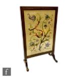 A 1920s oak framed firescreen raised to shallow cabriole legs with pad feet, the central panel