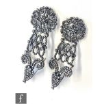 A pair of early 19th Century steel cut open work drop earings of florette and loop design, length