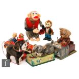 A collection of Japanese tinplate and plastic toys to include a Nomura Playful Puppy, a Cragstan