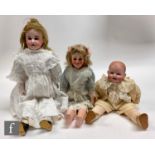 A collection of assorted bisque dolls, comprising a late 19th Century shoulder head doll, probably