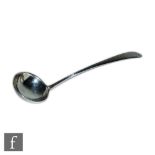 An Irish provincial silver sauce ladle with bright cut border and vacant cartouche, length 20cm,