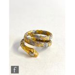 A yellow and white 18ct gold snake ring with single diamond set to the head, weight 5.6g, ring