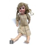 An early 20th Century Schoenau and Hoffmeister bisque socket head doll, with sleeping brown eyes,