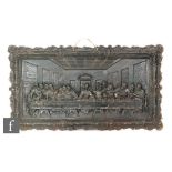A Coalbrookdale style cast iron plaque of The Last Supper in leaf and scroll frame, 44cm x 72cm.