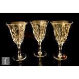 Three large Tudor crystal wine glasses with bell form bowl above facet cut stem, the bowls cut