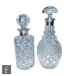 Two modern hallmarked silver and clear cut glass decanter, each with glass bodies below silver