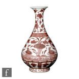 A Chinese Hongwu style copper-red pear shaped vase Yuhuchunping, Qing Dynasty (1644-1912), decorated