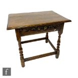 An 18th Century oak side table with later carved frieze drawer, on turned baluster legs and block