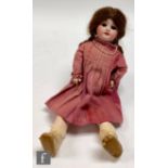 A 1920s French SFBJ bisque socket head doll, with sleeping eyes, open mouth with teeth, repainted