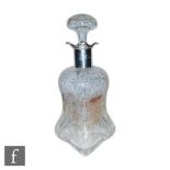An Edwardian hallmarked silver and clear cut glass decanter, the Steven & Williams polished intaglio