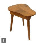 An Arts and Crafts oak cricket table, the saddle shaped top over chamfered legs, unlabelled,
