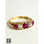 An early 20th Century 18ct ruby and diamond five stone ring, central ruby approximately 4.2mm,