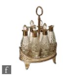 A George III hallmarked silver boat shaped cruet stand with six conforming pedestal bottles,