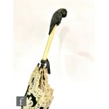 A late Victorian black lace edged parasol, the handle carved in the form of an owl, height 82cm.