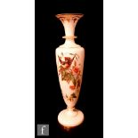 A late 19th Century French glass vase of footed slender form with a flared collar neck, enamelled