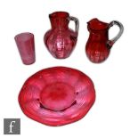 A late 19th Century cranberry glass jug of fluted spherical form with collar neck and applied