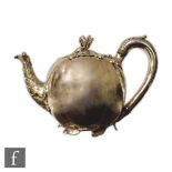 A William IV hallmarked silver melon shaped tea pot the plain cushion hexagonal body below a leaf
