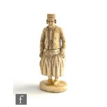 A 19th Century French carved ivory needlecase in the form of a pantaloon fisherman, height 8cm.