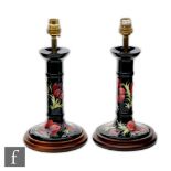 A pair of Moorcroft Pottery candlestick table lamps decorated in the Anemone pattern, marks obscured