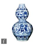 A Chinese blue and white double gourd vase, the octagonal vase decorated with fan shaped panels
