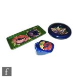 Three pieces of Moorcroft comprising a Frilled Orchid pattern roll rim bowl, diameter 12.5cm, S/D, a
