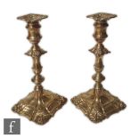 A pair of hallmarked silver candlesticks, shaped square stepped bases below knopped column and