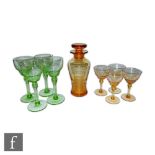 A 1930s Stuart and Sons stratford shape cocktail shaker with four matched glasses in golden amber