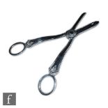 A pair of hallmarked silver grape scissors with palmette detail below finger holes, length 16.5cm,