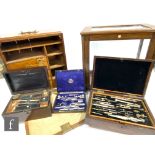 A part set of drawing instruments in a rosewood work box, a part leather set, a rosewood writing
