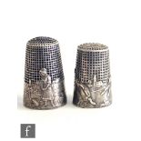 Two French silver thimbles one depicting the tortoise and the hare, the other with milkmaid and farm